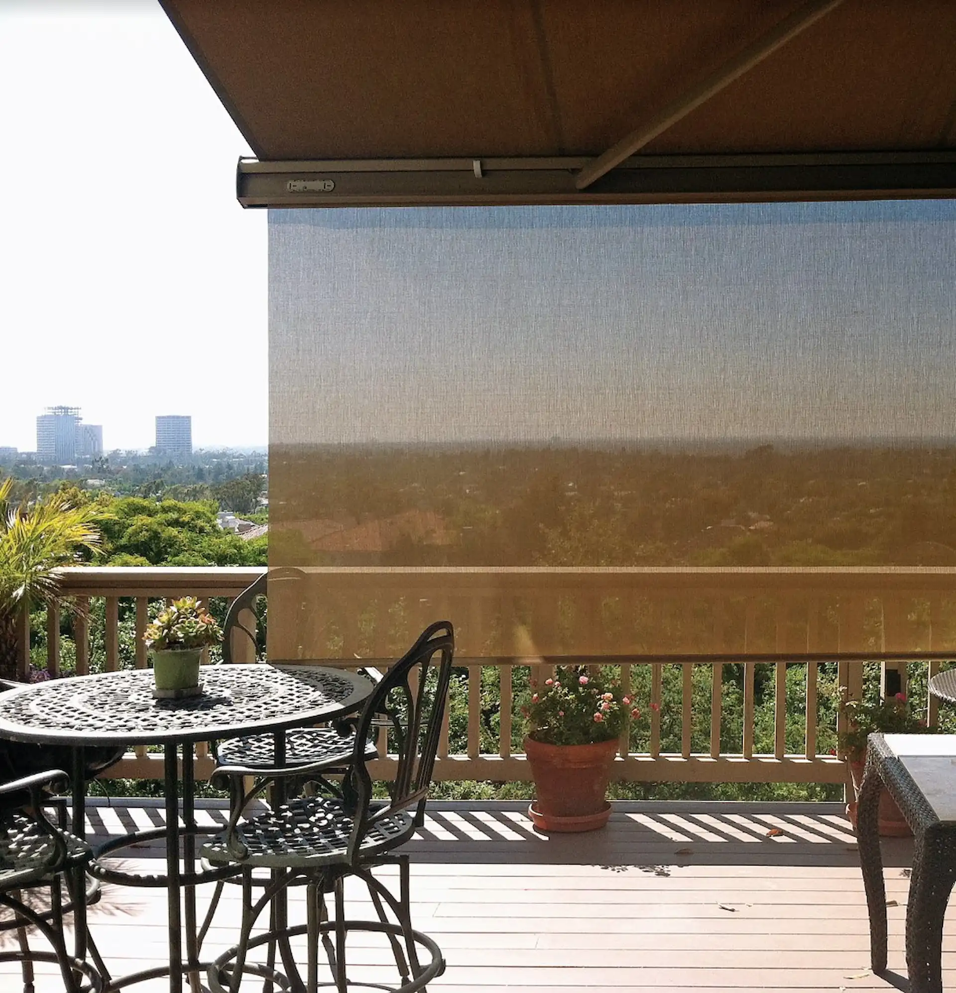 Medium shot of a drop screen hanging from the front bar of a retractable awning.